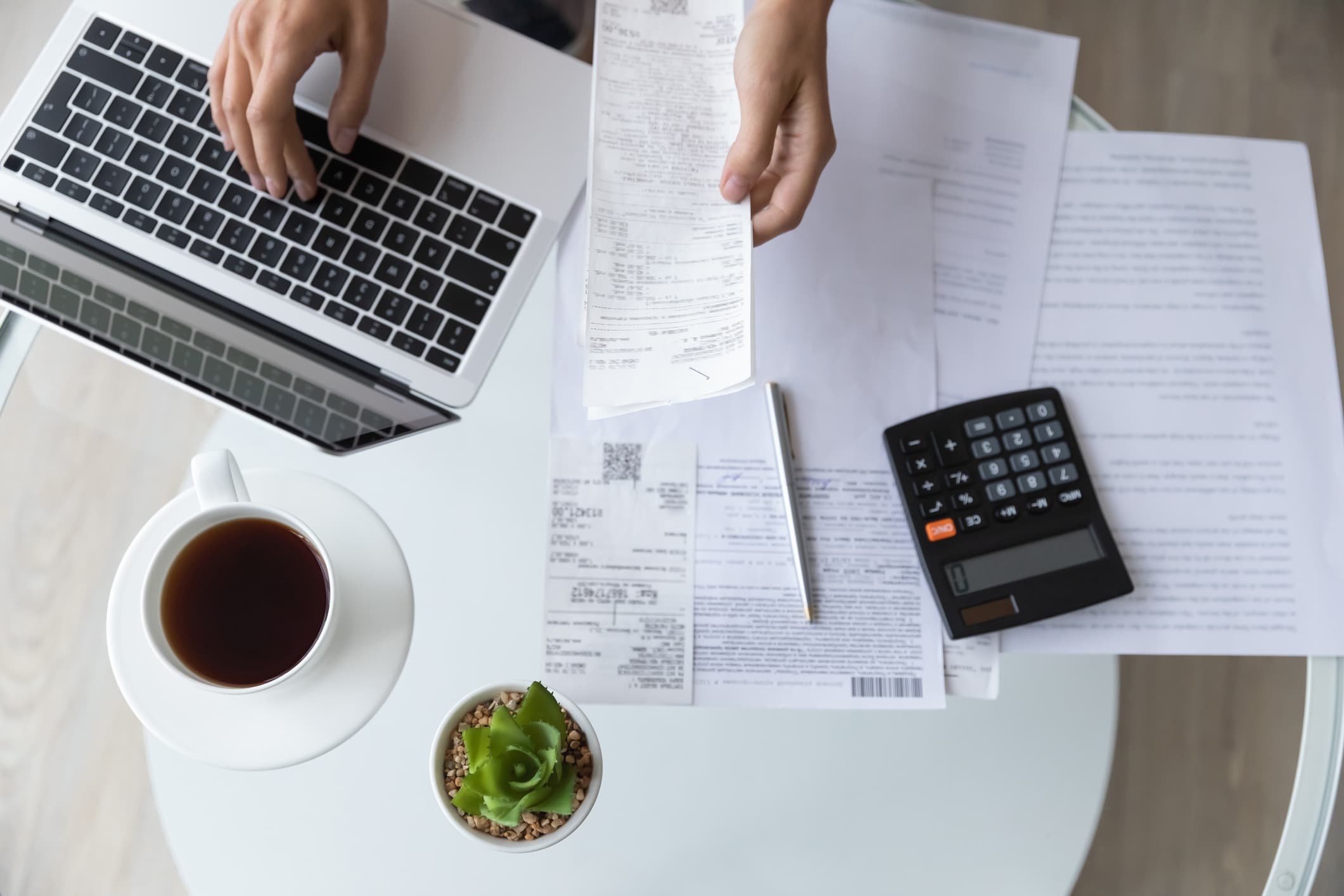 laptop, calculator and paperwork